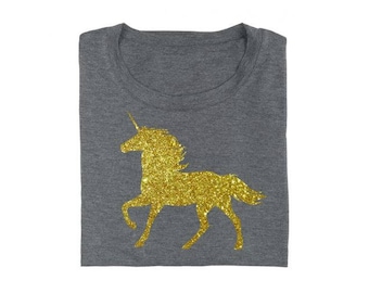 May include: A gray t-shirt with a gold glitter unicorn silhouette.