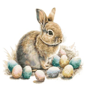 May include: A brown rabbit sits in a nest of grass and pastel colored Easter eggs.