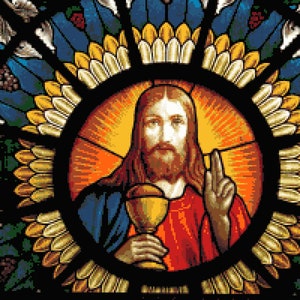 Puede incluir: Vidriera que representa una figura con pelo largo, barba y túnica roja, sosteniendo un cáliz. La figura está rodeada por un halo y un diseño circular con detalles azules, amarillos y verdes.