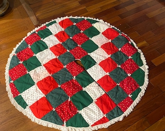 Vintage extra large quilted Christmas tree skirt with white trim.