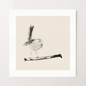 May include: A square art print featuring a black ink illustration of a small bird perched on a horizontal branch. The bird has a long, upright tail and delicate features, rendered in a minimalist style against a solid, light beige background.