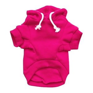 May include: A bright pink hooded sweatshirt for a pet. The sweatshirt has a white drawstring and is made of a soft, comfortable material.