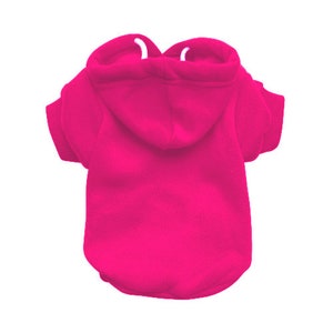 May include: A bright pink hooded sweatshirt for a small dog. The sweatshirt has short sleeves and a drawstring hood.