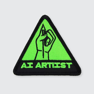 May include: A black and green triangular patch with a hand holding a pencil and the text "AI ARTIST" in black.