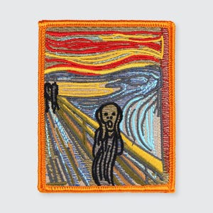 May include: Embroidered patch featuring Edvard Munch's "The Scream" painting. The patch has a rectangular shape with an orange border. The artwork depicts a figure with an open mouth against a swirling sky of red, yellow, and blue.