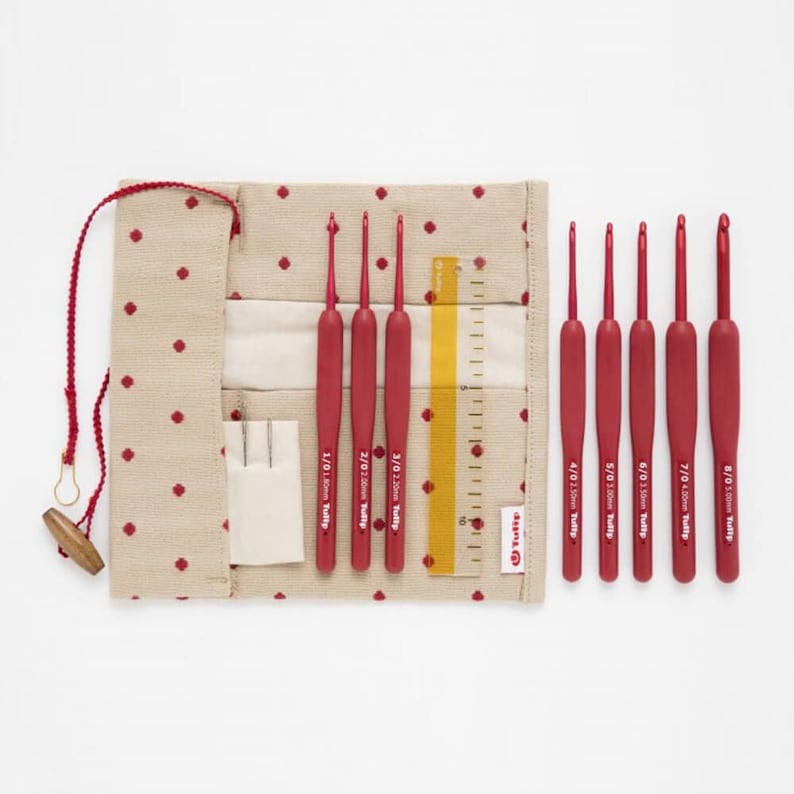 May include: A set of ten red crochet hooks in a beige and red polka dot carrying case. The hooks are labeled with their size and "Tulip".