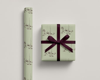 May include: A roll of wrapping paper and a wrapped gift box. Both are pale green with a repeating pattern of sketched botanical elements in brown. The gift box is tied with a dark purple ribbon.