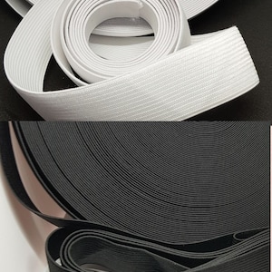 May include: Two rolls of elastic, one white and one black. Both rolls are made of a woven elastic material.