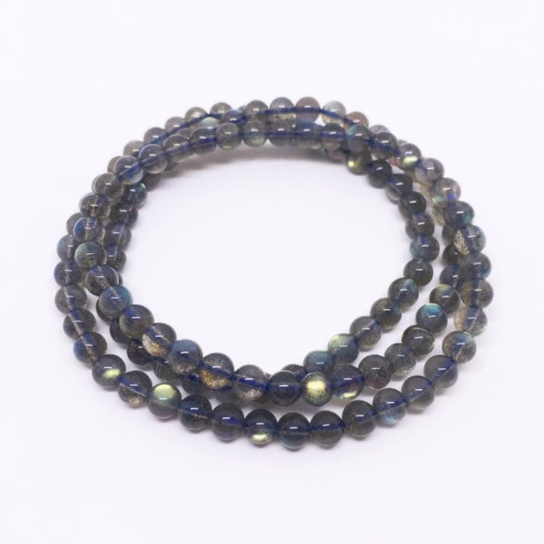 May include: A multi-strand bracelet made of dark blue labradorite beads. The beads have a subtle iridescent sheen.