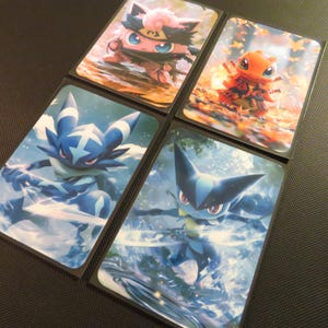May include: Four rectangular trading card sleeves featuring illustrations of animated creatures. One shows a pink creature with a black headband, one an orange creature in autumn leaves, and two show blue creatures with sharp blades in motion.