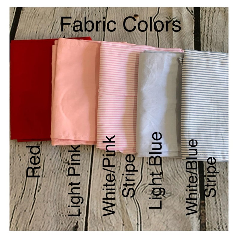 May include: Fabric swatches in red, light pink, white with pink stripes, light blue, and white with blue stripes. The text "Fabric Colors" is at the top of the image.