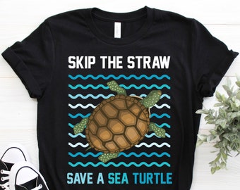 May include: Black t-shirt with a graphic of a sea turtle swimming in blue waves. The text "Skip the Straw Save a Sea Turtle" is printed on the shirt.