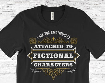 May include: Black t-shirt with the text "I AM TOO EMOTIONALLY ATTACHED TO FICTIONAL CHARACTERS" in white and gold lettering. The design includes decorative elements and book illustrations. A casual tee for book lovers.