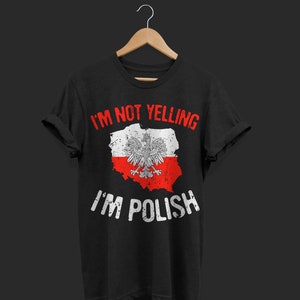 May include: Black t-shirt with the text "I'M NOT YELLING I'M POLISH" in white and red. The design features a distressed Polish flag with the Polish coat of arms.