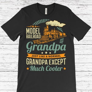 May include: Black t-shirt with a vintage-style design featuring a model railway train and the text "I'm a Model Railway Grandpa Just Like a Normal Grandpa Except Much Cooler".