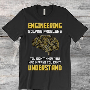 May include: Black t-shirt with a yellow graphic of a brain with circuit board patterns. The text "ENGINEERING SOLVING PROBLEMS YOU DIDN'T KNOW YOU HAD IN WAYS YOU CAN'T UNDERSTAND" is printed on the shirt.