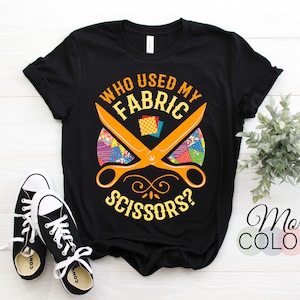 May include: Black t-shirt with a graphic of scissors cutting fabric and the text "Who used my fabric scissors?"