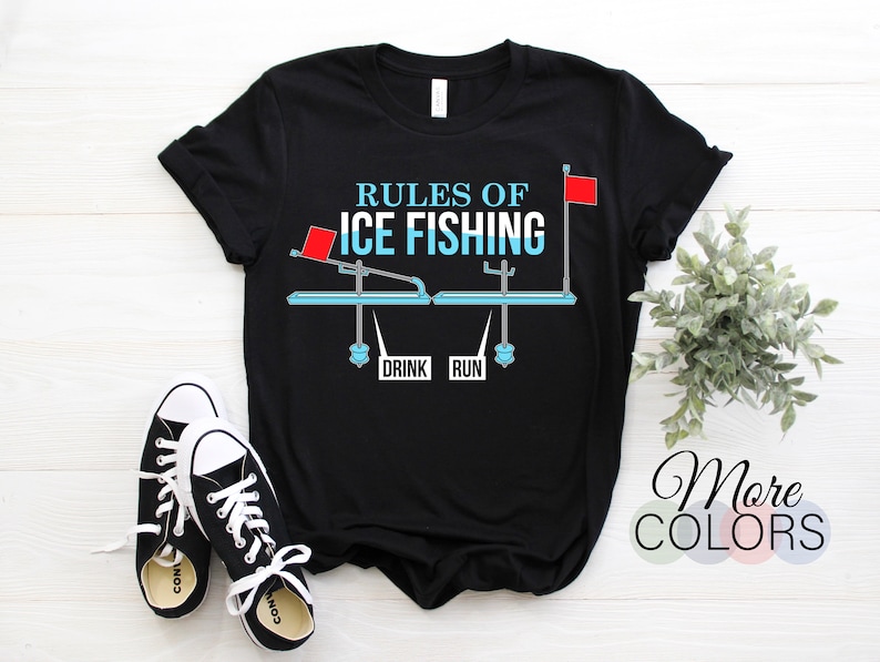 May include: Black t-shirt with a white graphic of a seesaw with the words "Rules of Ice Fishing" and "Drink" and "Run" on it. The seesaw has a red flag on each end.
