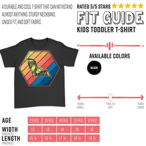 May include: Black toddler t-shirt with a bat graphic inside a retro-style hexagon. The bat is yellow and orange, set against red, orange, blue, and yellow stripes. The shirt has the text "A durable and cool t-shirt that can withstand almost anything."