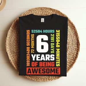 May include: Black t-shirt with colorful text that reads "189302400 Seconds, 72 Months, 52584 Hours, 2191 Days, 3155040 Minutes, 6 Years of Being Awesome".