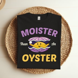 May include: Black t-shirt with a purple and yellow cartoon oyster and the text "Moister Than An Oyster".