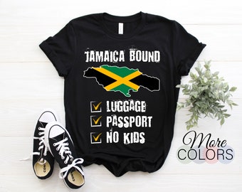 May include: Black t-shirt with a white graphic of the Jamaican flag and the text "Jamaica Bound". Below the flag is a checklist with the text "Luggage", "Passport", and "No Kids" with checkmarks next to each item.