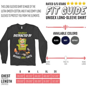 May include: A black long-sleeved shirt with the text "Easily Distracted by Books and Cats" and an illustration of a cat sitting in an armchair with a stack of books. The shirt is available in black, navy, and asphalt colors. The size chart shows chest and length measurements in inches.