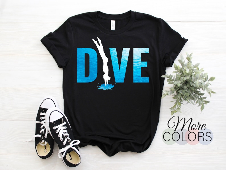 May include: Black t-shirt with a white silhouette of a person diving into blue water with the word "DIVE" in white letters.