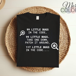 May include: Black t-shirt with white text that reads "99 little bugs in the code, 99 little bugs. Take one down, patch it around, 117 little bugs in the code..."