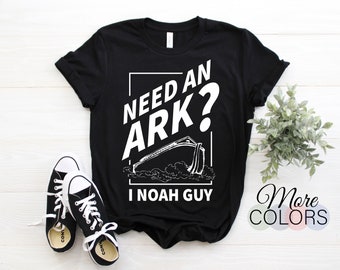 May include: Black t-shirt with white text that reads "Need an Ark? I Noah Guy" and a graphic of a boat on water.