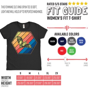 May include: Black women's fit t-shirt with a bat graphic inside a retro-style hexagon. The bat is yellow and the hexagon has orange, red, blue, and yellow stripes. Available in sizes S to 2X, with widths from 17.00" to 25.00" and heights from 25.00" to 28.00".