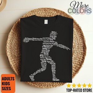 May include: Black t-shirt with a white graphic of a discus thrower composed of words related to the sport. The shirt includes the text "ADULTS KIDS SIZES" and "TOP-RATED STORE". The words "More COLORS" are also visible.