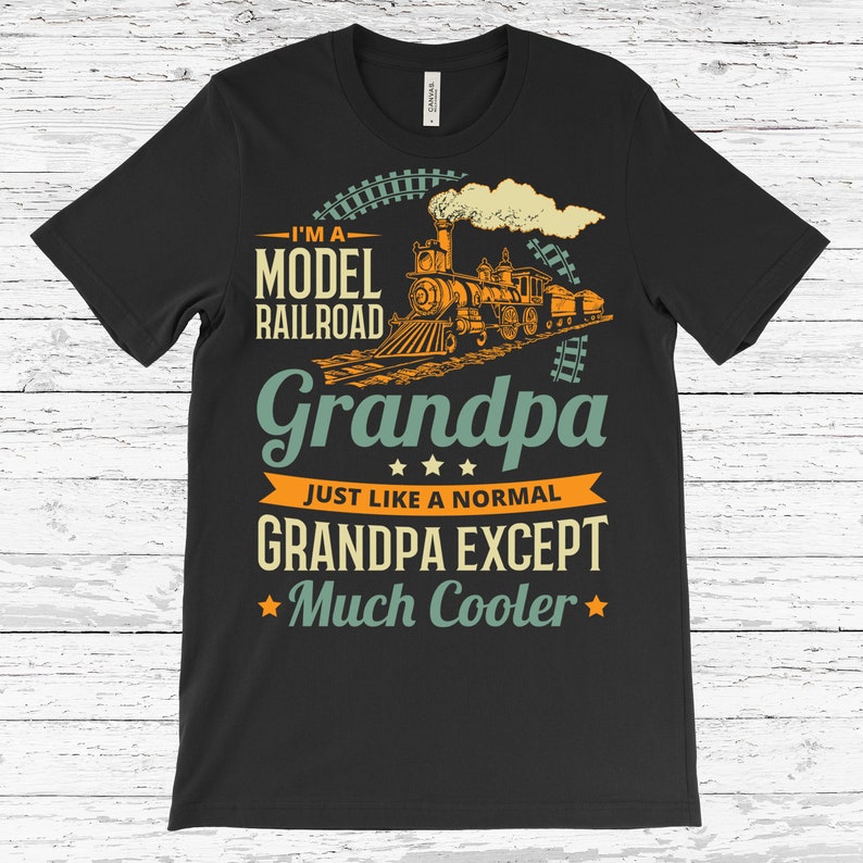 May include: Black t-shirt with a vintage-style design featuring a model railway train and the text "I'm a Model Railway Grandpa Just Like a Normal Grandpa Except Much Cooler".