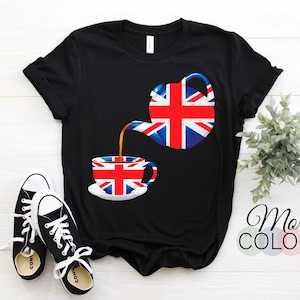 May include: Black t-shirt with a graphic of a teapot pouring tea into a cup. Both the teapot and cup are decorated with the Union Jack flag.