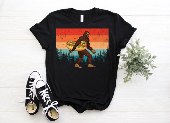 Bigfoot Carrying Hotdog Retro Vintage T-Shirt Bigfoot Carrying Hotdog Retro Vintage T-Shirt