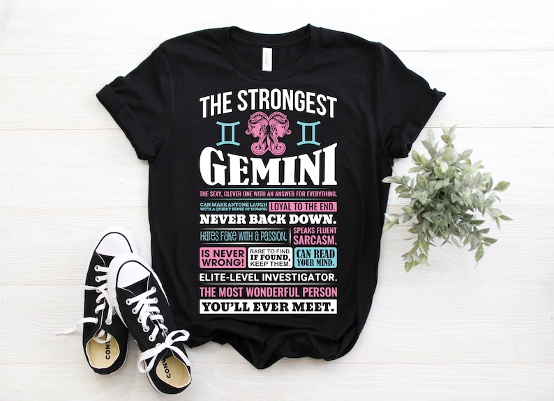 May include: Black t-shirt with a white graphic design featuring the Gemini zodiac sign and text that reads "The Strongest Gemini. The sexy, clever one with an answer for everything. Can make anyone laugh with a quirky sense of humor. Loyal to the end. Never back down. Hates fake with a passion. Speaks fluent sarcasm. Is never wrong! Rare to find, if found, keep them. Can read your mind. Elite-level investigator. The most wonderful person you'll ever meet."