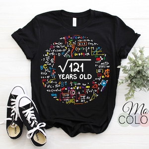 May include: Black t-shirt with a colorful graphic of math equations and the text "√121 YEARS OLD".