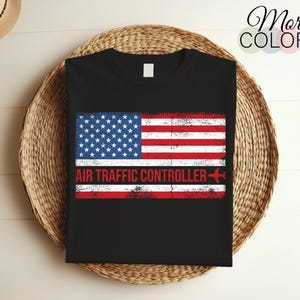 May include: Black t-shirt with a distressed American flag design and the text "AIR TRAFFIC CONTROLLER" with a small airplane icon.
