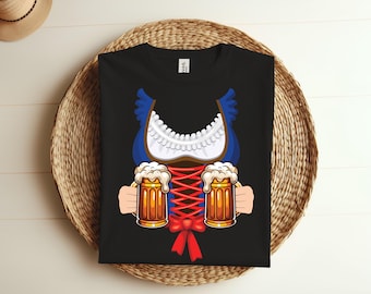 May include: Black t-shirt with a blue and white dirndl design and two beer mugs. The dirndl has red ribbon accents and a white lace trim.