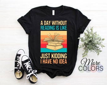 May include: Black t-shirt with the text "A DAY WITHOUT READING IS LIKE JUST KIDDING I HAVE NO IDEA" and a graphic of open books. The design features a retro color scheme. The image also shows black and white trainers.