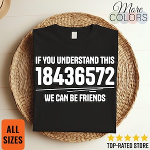 May include: Black t-shirt with white text: "IF YOU UNDERSTAND THIS 18436572 WE CAN BE FRIENDS." The shirt is displayed on a woven basket. The words "More Colors", "All Sizes", and "Top-Rated Store" are also visible.