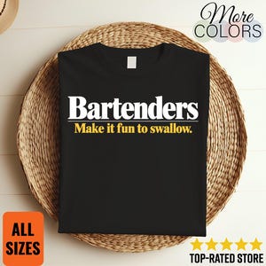 May include: A black short-sleeved t-shirt featuring the white text "Bartenders" in a bold serif font, underlined by a white line, with the yellow text "Make it fun to swallow." printed directly underneath the line on the front of the garment.