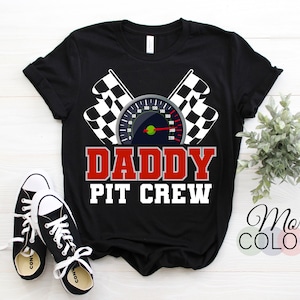 May include: Black t-shirt with a white checkered flag, a speedometer, and the text "Daddy Pit Crew" in red and white.