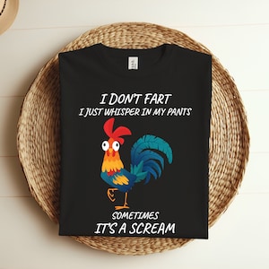 May include: Black t-shirt with a colorful rooster graphic and the text "I don't fart, I just whisper in my pants. Sometimes it's a scream." The rooster is depicted with red, yellow, blue, and orange feathers.