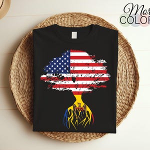 May include: A black t-shirt featuring a tree design. The tree is formed from the American flag and the flag of Moldova. The tree is rooted in the ground and has branches reaching up to the sky.