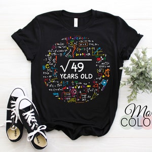 May include: Black t-shirt with a colorful graphic of mathematical equations and the text "√49 YEARS OLD".