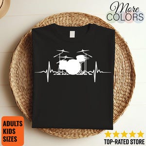 May include: Black t-shirt with a white drum kit graphic and a heartbeat line. The shirt has the text "More Colors" and "Adults Kids Sizes". The image also shows a "Top-Rated Store" badge.