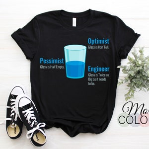 Puede incluir: Camiseta negra con un gráfico de un vaso de agua y texto que dice "Optimista: El vaso está medio lleno. Pesimista: El vaso está medio vacío. Ingeniero: El vaso es el doble de grande de lo que necesita ser."