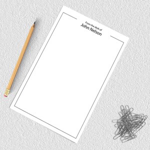 May include: A blank white sheet of paper with a black border and the text "From the desk of John Nelson" at the top.