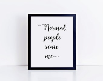 May include: A framed print with the words "Normal people scare me" in elegant black script on a white background. The frame is black, and the print is displayed on a white surface.